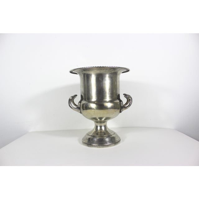 This is a trophy cup style, elegant silver plated ice bucket with handles. This bucket has patina, scratches, spots of...