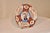 Circa 1900 Imari charger from Japan with a central medallion, containing a hand painted picture of a potted plant,...