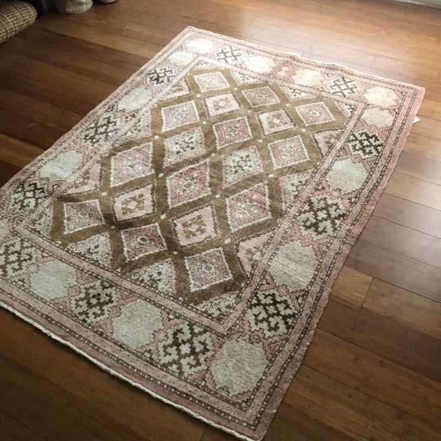 A Vintage Kurdish Rug in Soft Pink and Earthy Browns This remarkable vintage Kurdish rug is a celebration of quiet...