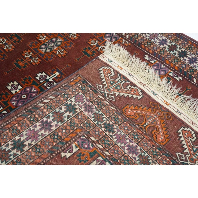 In the style of larger Yomud tribal main tent carpets, this nomadic scatter shows color diagonals of Kepse emblematic guls...