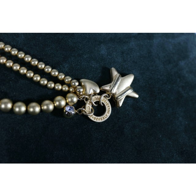 This is part of Chairish’s Costume Jewelry assortment. Chic gold brushed tone beaded 3 strand bracelet with dangling...