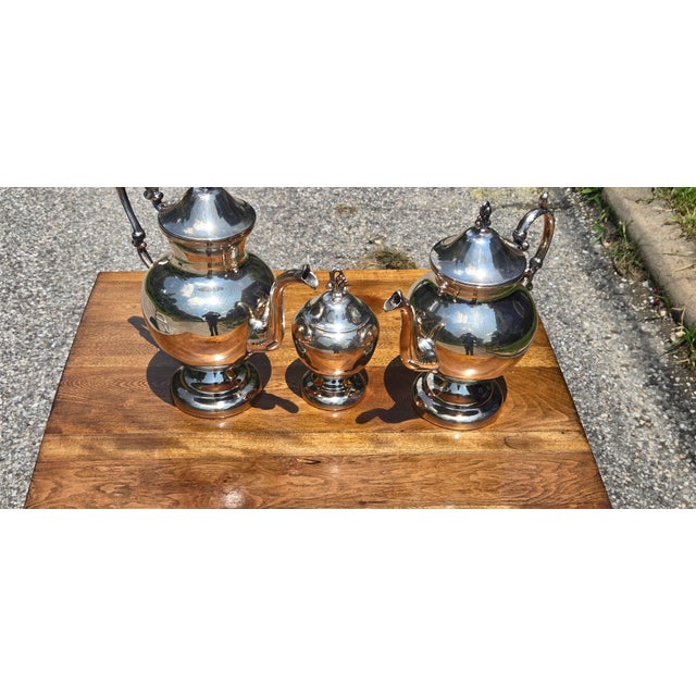 Elevate your entertaining with this elegant vintage 3-piece silver-plated coffee and tea service. The set includes a...