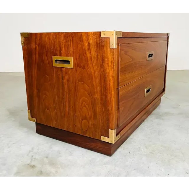 Handsome 2-drawer Campaign Style chest having solid walnut construction with brass pulls, side handles and corner accents....