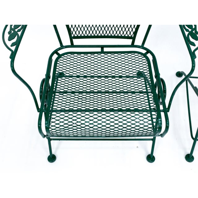 A set of four forest green vintage "Bouncy" Woodard "Briarwood" or "Daisy" wrought iron bouncer chairs, likely from the...
