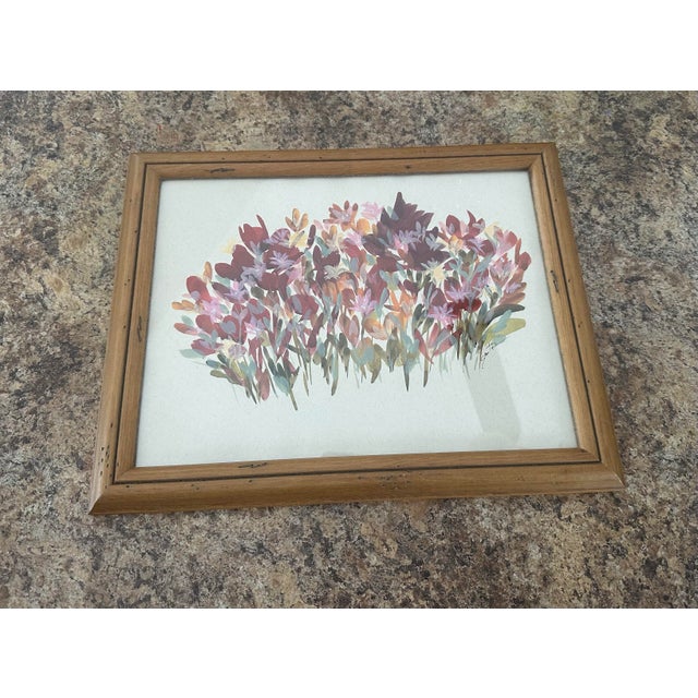 A soft, impressionistic cluster of flowers painted in gentle pastels and earthy reds evokes the warmth of an early autumn...