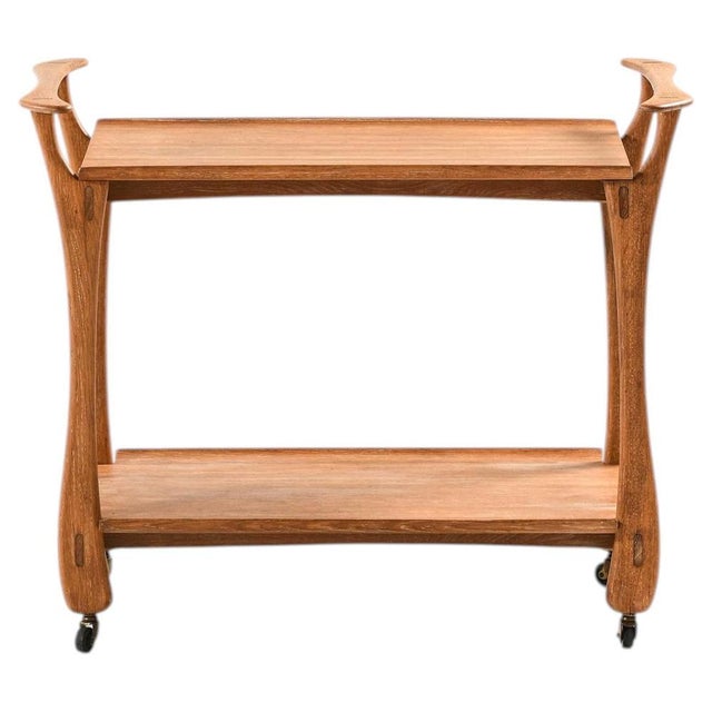 This rare trolley, crafted in the style of Jens Quistgaard and likely produced in Denmark during the 1950s, reflects the...