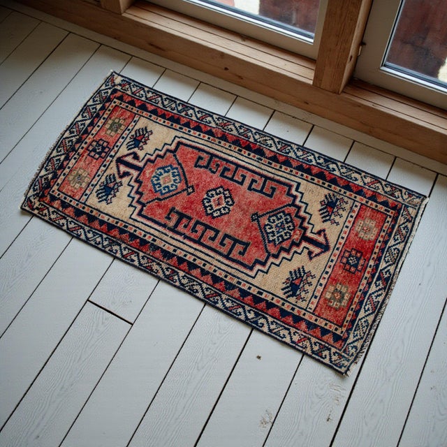 Welcome this authentic vintage Anatolian mat into your home, a beautifully hand-knotted piece that brings immediate warmth...