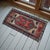 Welcome this authentic vintage Anatolian mat into your home, a beautifully hand-knotted piece that brings immediate warmth...