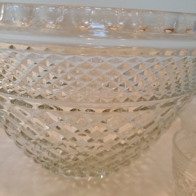 This Vintage Anchor Hocking Glass Punch Bowl Set with 12 Matching Cups is a classic piece of American-made glassware. The...