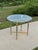 Hollywood Regency end table styled after designs by Maison Jansen, featuring polished brass and chrome construction. Art...