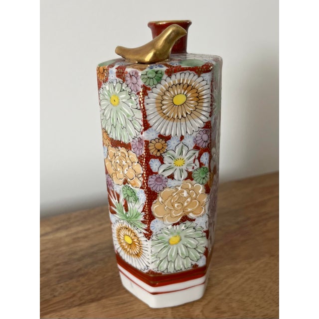 A gorgeous hand-painted, hexagon, Kutani Ware sake bottle in the Hanazume style stemming from the early 1900s-featuring...