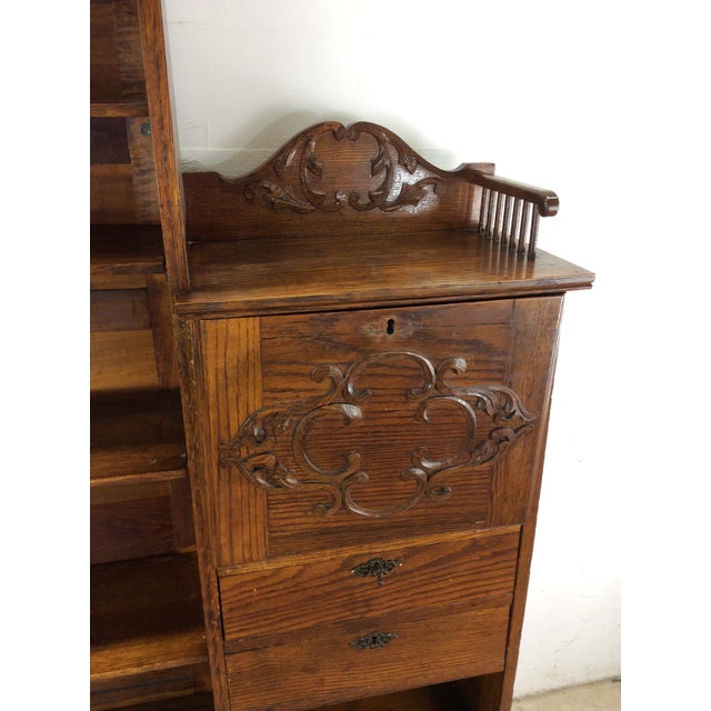 This antique bookcase and writing desk side by side features hardwood construction, original oak finish, three adjustable...