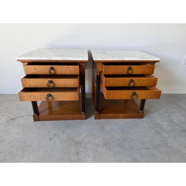 Elegant pair of Baker Furniture nightstands featuring a refined Hollywood Regency design. Crafted in rich cherry wood,...