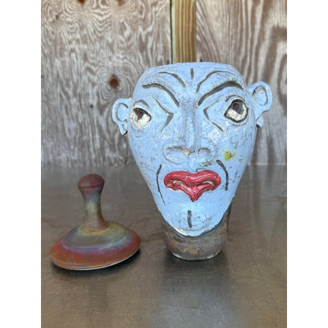 This striking sculptural jug is a whimsical yet bold ceramic piece that doubles as functional art, shaped into a stylized...