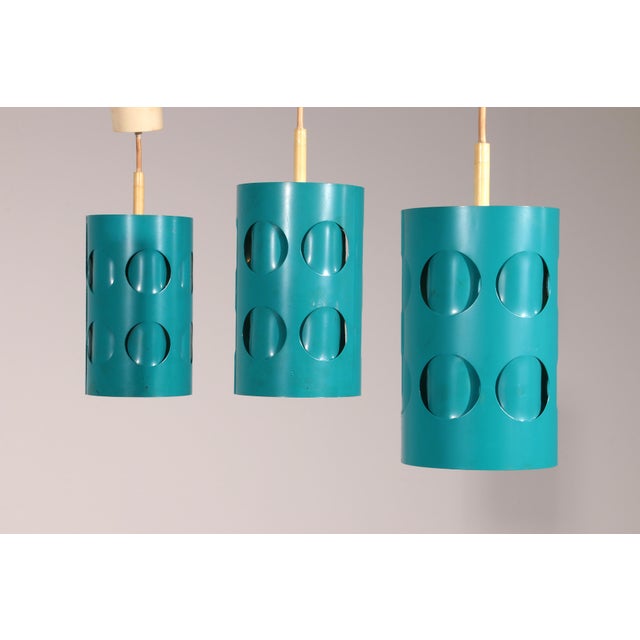 Step into the golden era of Dutch design with this rare set of three Raak Amsterdam pendant lamps. Crafted in the 1970s,...