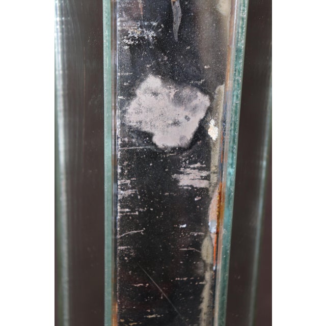 This rare églomisé paint decorated mirrored floor lamp, attributed to the iconic French design house Maison Jansen,...