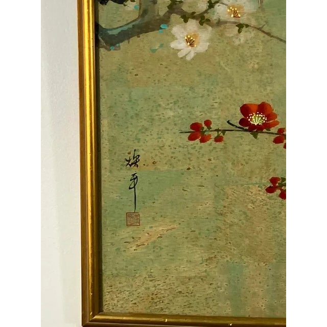 A hand-painted cork artwork by Teng Ping, featuring two long-tailed birds perched gracefully on a blossoming branch with...