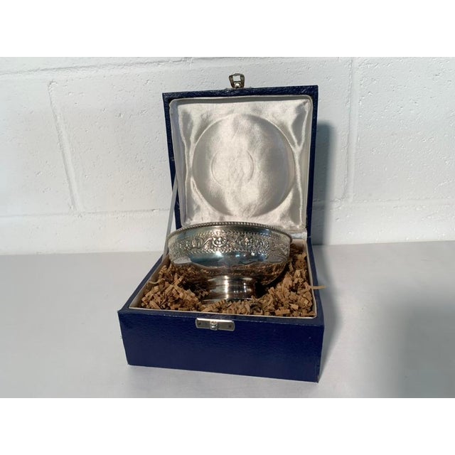 This elegant bowl features an exceptionally detailed, continuous band of hand-chased scrolling coriander leaves, dense...