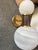 Dumbbell style sconce with offset globes of opal swirl glass with a gray-washed wood neck and antique brass mounting...