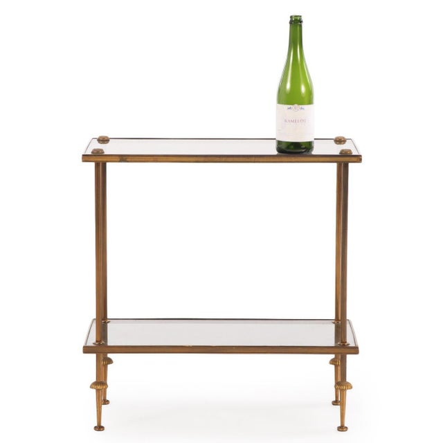 Elegant and sleek two-tier end table, perfect for displaying your books or collections. This vintage Neoclassical accent...