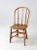 This antique bow back dining chair embodies the timeless character of early American farmhouse design. The rounded spindle...