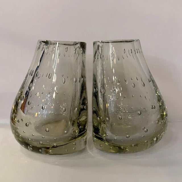 This wonderfully unique pair of mid-century modern glass vases double as bookends for a fantastic accent in any room. The...