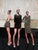 Land by Michael Carson | Oil on Panel Three figures in stylish outfits standing together For Sale