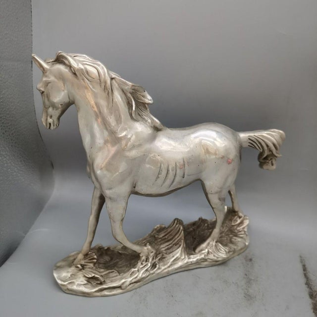 Add a touch of equestrian elegance and dynamic movement to your decor with this striking vintage horse sculpture. Crafted...