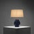 This Danish stoneware table lamp from the 1960s combines a deeply textured blue and white glazed base with a slender brass...