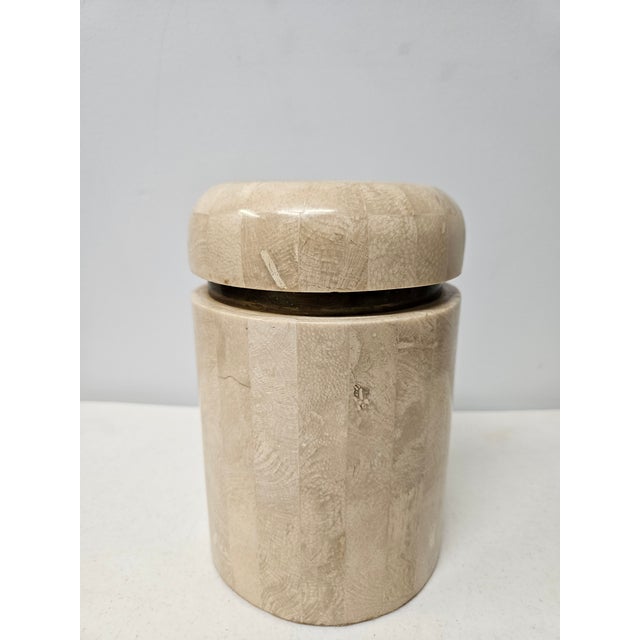 This tessellated stone and brass lidded jar or trinket box has a felt lining. The piece is made in the Philippines and is...