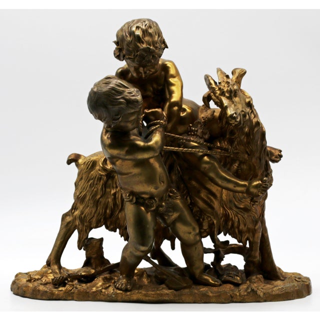 Summary Substantial French gilt bronze Bacchic group of two putti and a long-haired goat, modeled in the Rococo spirit...