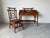 A beautifully crafted vintage desk and chair set in the timeless British Colonial style, featuring faux bamboo framing and...