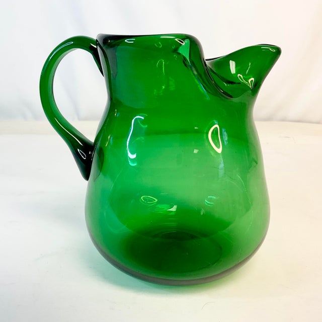 This is a lovely juice pitcher in Bottle Green glass. It’s Hand Blown and features a pinched spout. We are a big fan of...