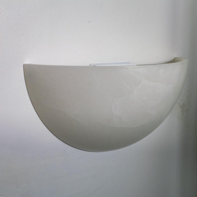 Pair of Art Deco inspired Spanish alabaster sconces. Each piece displays naturally occurring variations in color and veining.