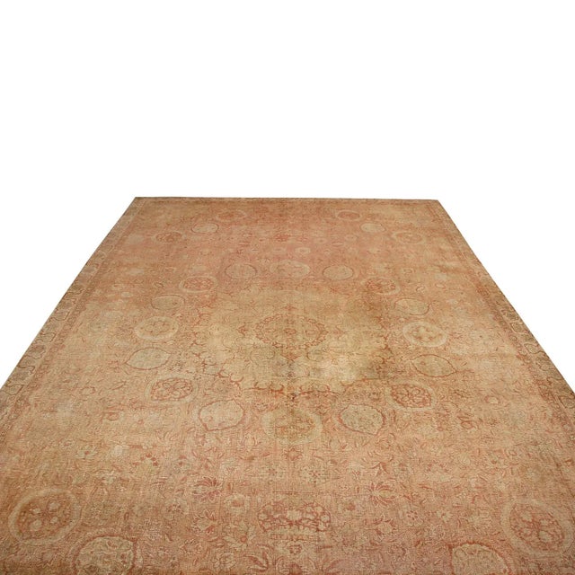 Hand-knotted in India originating between 1890-1900, this antique Amritsar wool rug enjoys a marriage of traditional...
