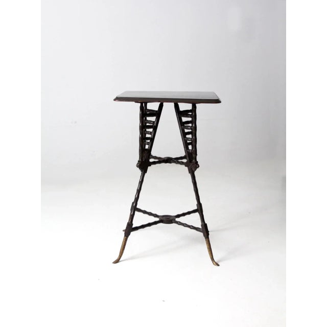 An antique Victorian end table featuring a decorative “stick and ball” design, showcasing the intricate craftsmanship of...