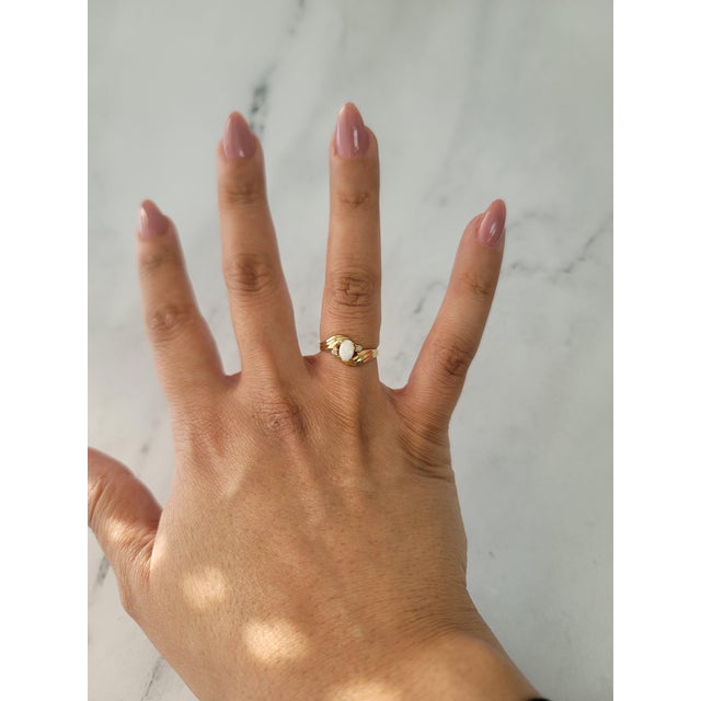 ♥ Product Summary ♥ Stone: Australian Opal Stone Cut: Oval Band Material: 10k Yellow Gold Weight: 2 grams