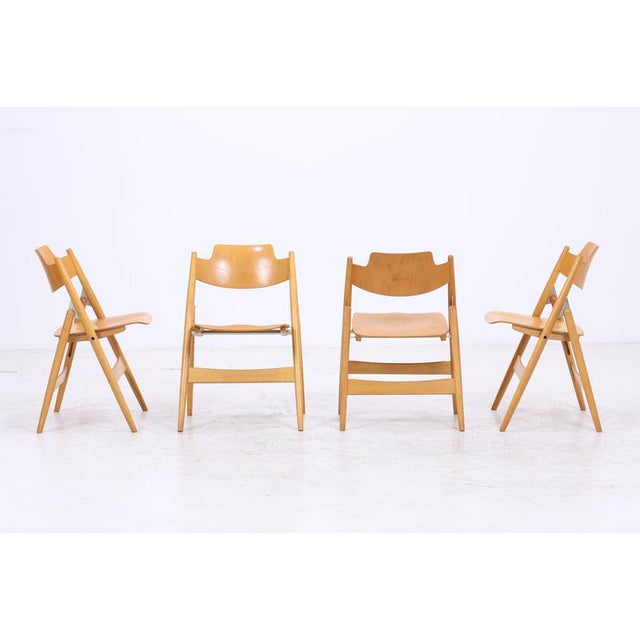 Set of four SE 18 folding chairs by Egon Eiermann for Wilde + Spieth. The characteristic design with its contoured seat...