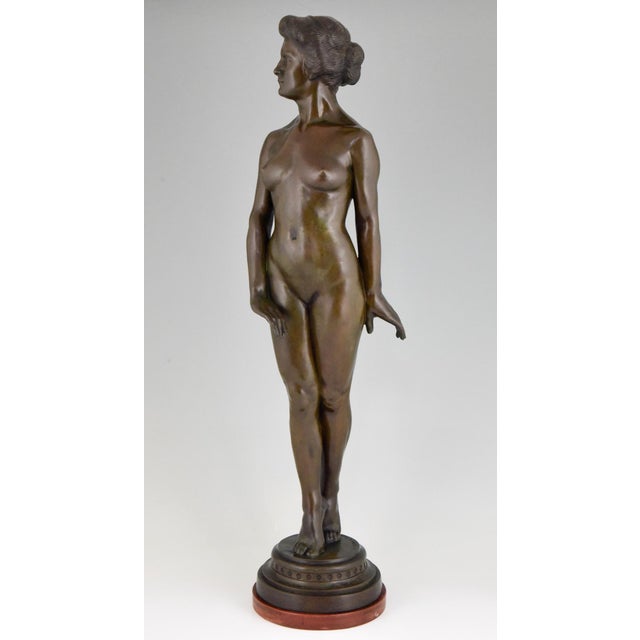 Tall Art Deco bronze sculpture of a standing nude by the German artist Wilhelm Oskar Prack on a circular wooden base. This...