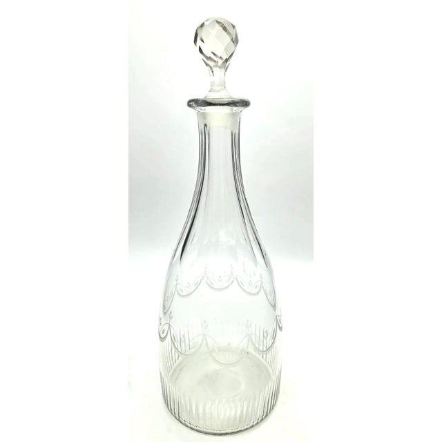 Offered is an antique Anglo-Irish style etched glass decanter and faceted crytal stopper, typically dating from the late...