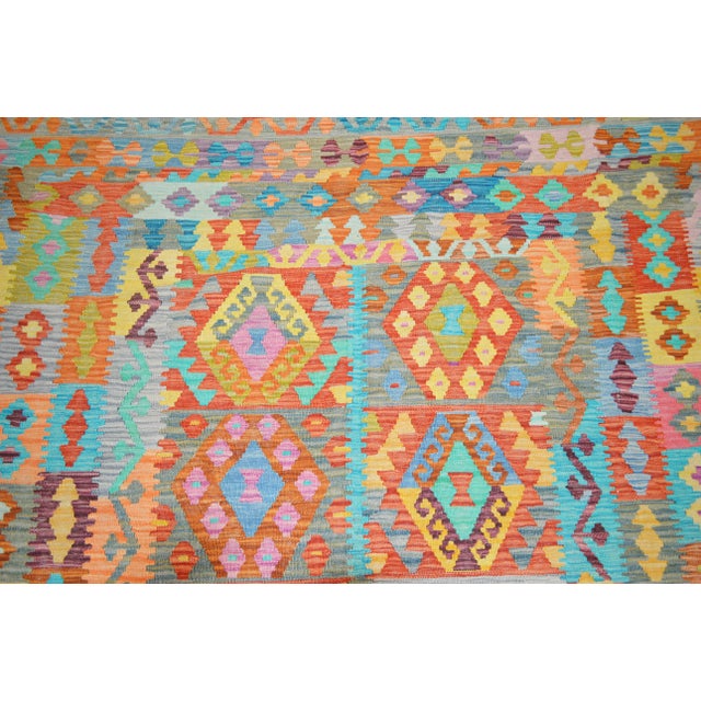 Vintage Afghan Maimana hand woven kilim with natural colors and geometric pattern.