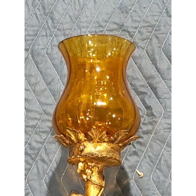 Circa 1890. Elegant French wall sconce crafted in gilt metal with classical foliate detailing and a slender torch-form...