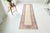 This is a vintage Turkish Oushak rug from the Mid 20th Century. The piece was hand-knotted.
