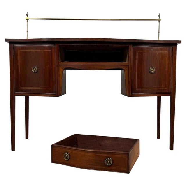 An elegant early 20th-century English sideboard, finely crafted from mahogany and distinguished by its decorative inlay,...