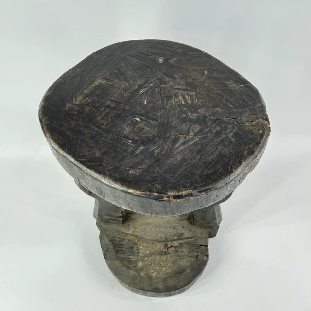 The Tabwa Stool with a fish design, originating from the Democratic Republic of Congo, stands as a striking example of the...