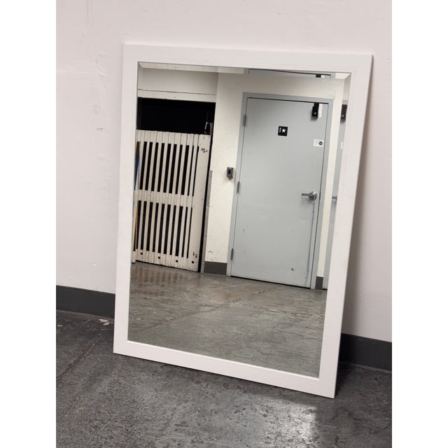 Design Plus Gallery presents a Contemporary White Dotted-Trim Rectangular Wall Mirror. The mirror has a broad white frame...