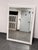 Design Plus Gallery presents a Contemporary White Dotted-Trim Rectangular Wall Mirror. The mirror has a broad white frame...