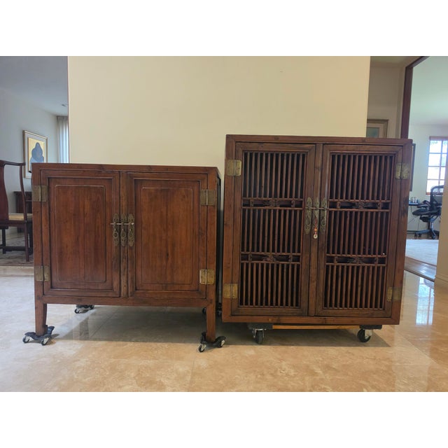 This kitchen cabinet has two sections - the top section has a solid frame with open lattice work on the front and on the...
