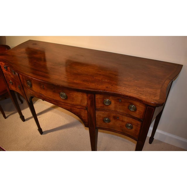From a local collection, this English Hepplewhite mahogany sideboard is circa 1785-30. The great old color and patina of...