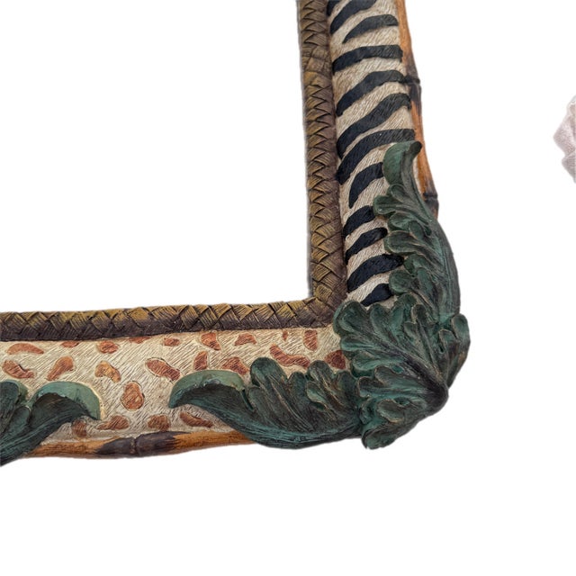 Late 20th Century resin wall mirror with faux bamboo accents and safari themed animal prints. Would fit great in a home...